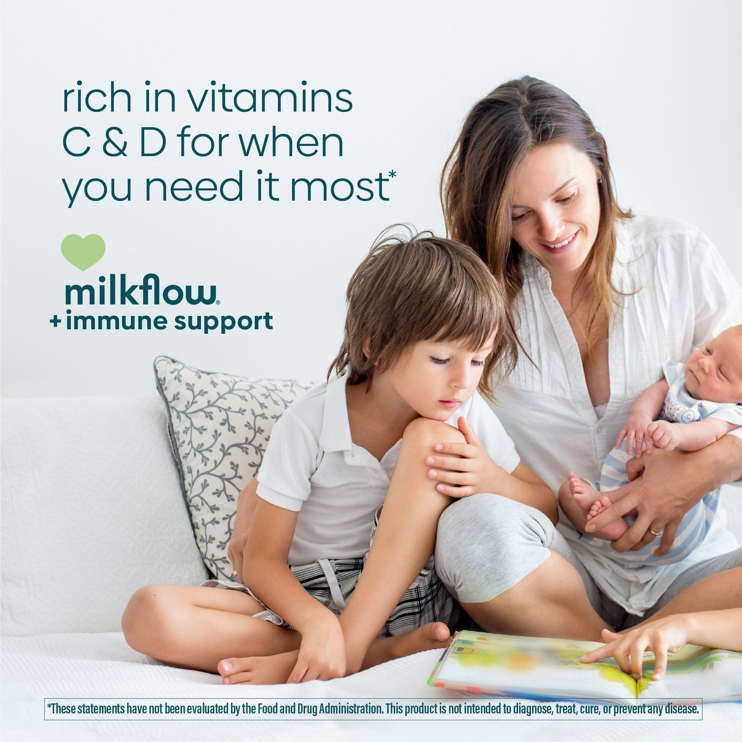 A mother holds her baby while reading a book with her toddler and does does with immune support from MilkFlow