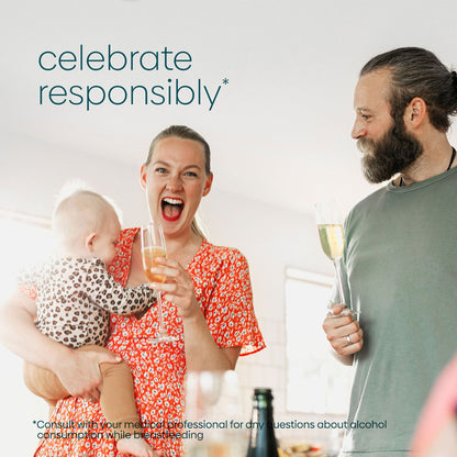 A woman holding her baby is excited to have champagne with her husband and she will use Milkscreen to test her breastmilk supply